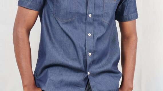 Blue denim two pocket short sleeved button down shirt